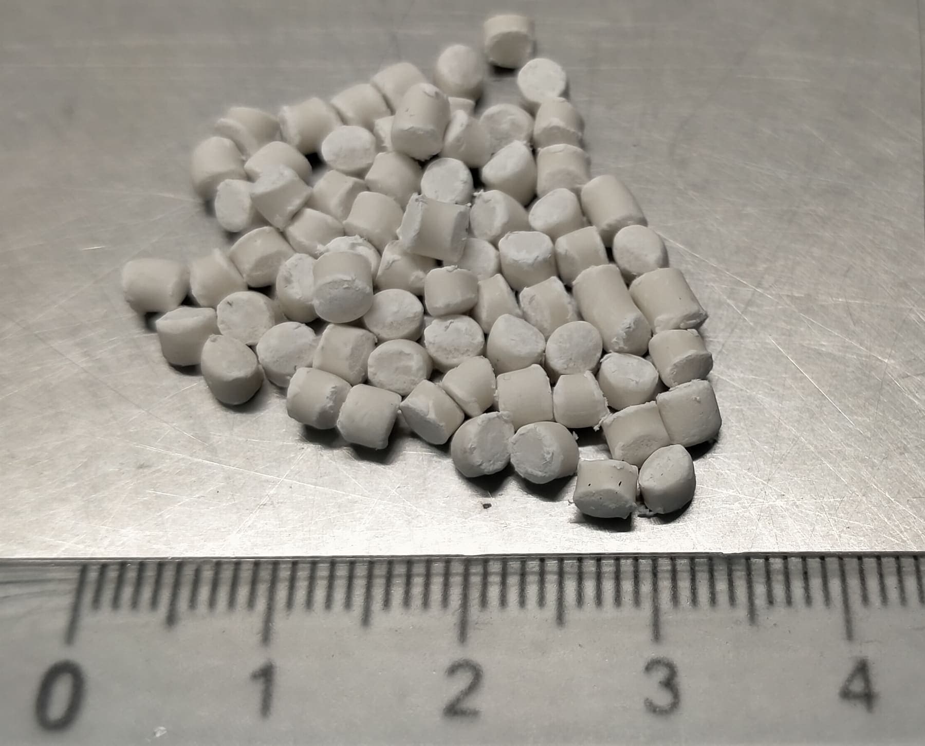 Masterbatch pellets next to a ruler